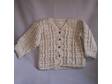 Post stitch crocheted baby sweater in soft acrylic yarn.